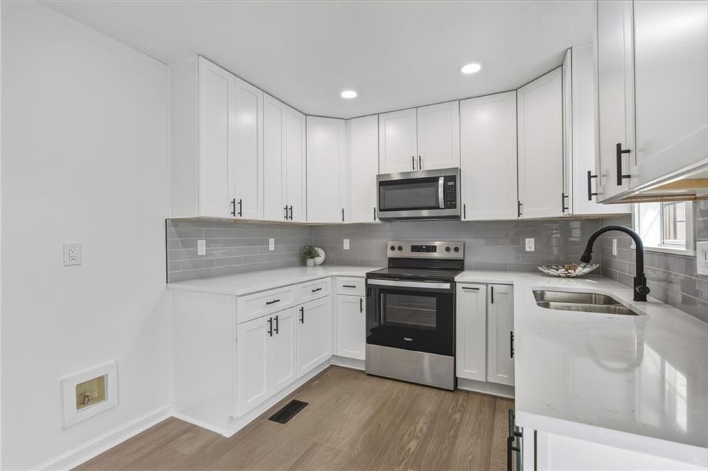 4457 Wesley Way Austell, GA 30106 - Photo 12 of 37 a kitchen with stainless steel appliances granite countertop a stove a sink and a microwave