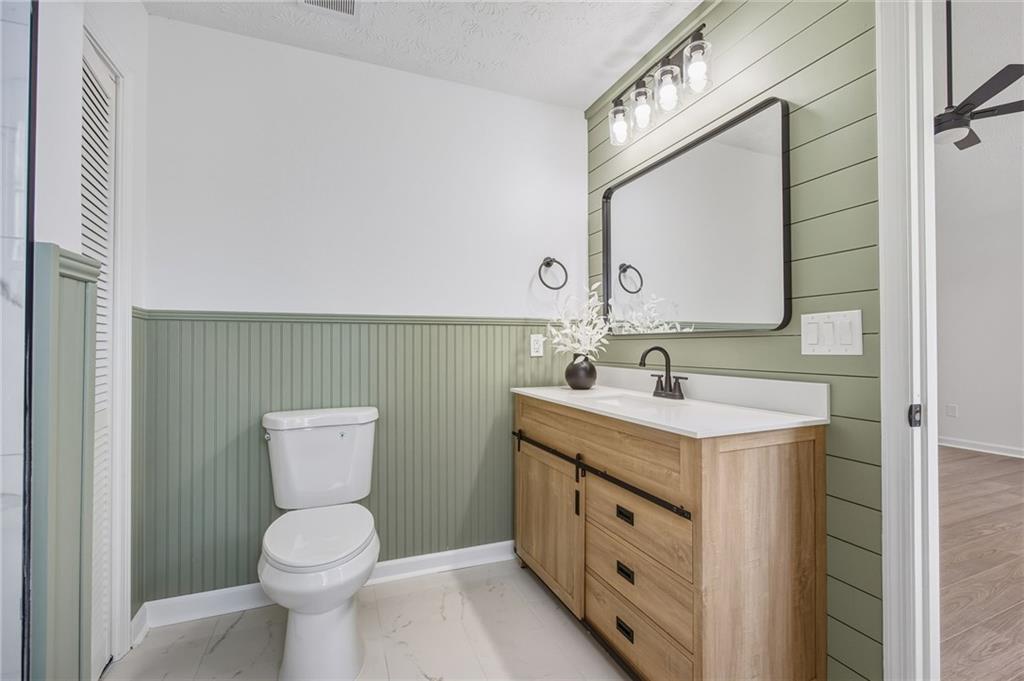 4457 Wesley Way Austell, GA 30106 - Photo 18 of 37 a bathroom with a toilet sink and mirror