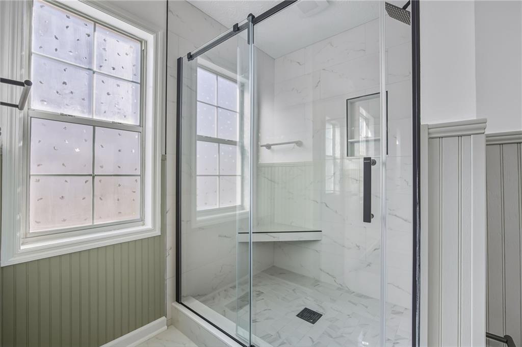 4457 Wesley Way Austell, GA 30106 - Photo 19 of 37 a bathroom with a glass shower door
