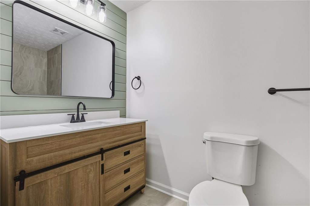 4457 Wesley Way Austell, GA 30106 - Photo 21 of 37 a bathroom with a toilet sink and mirror