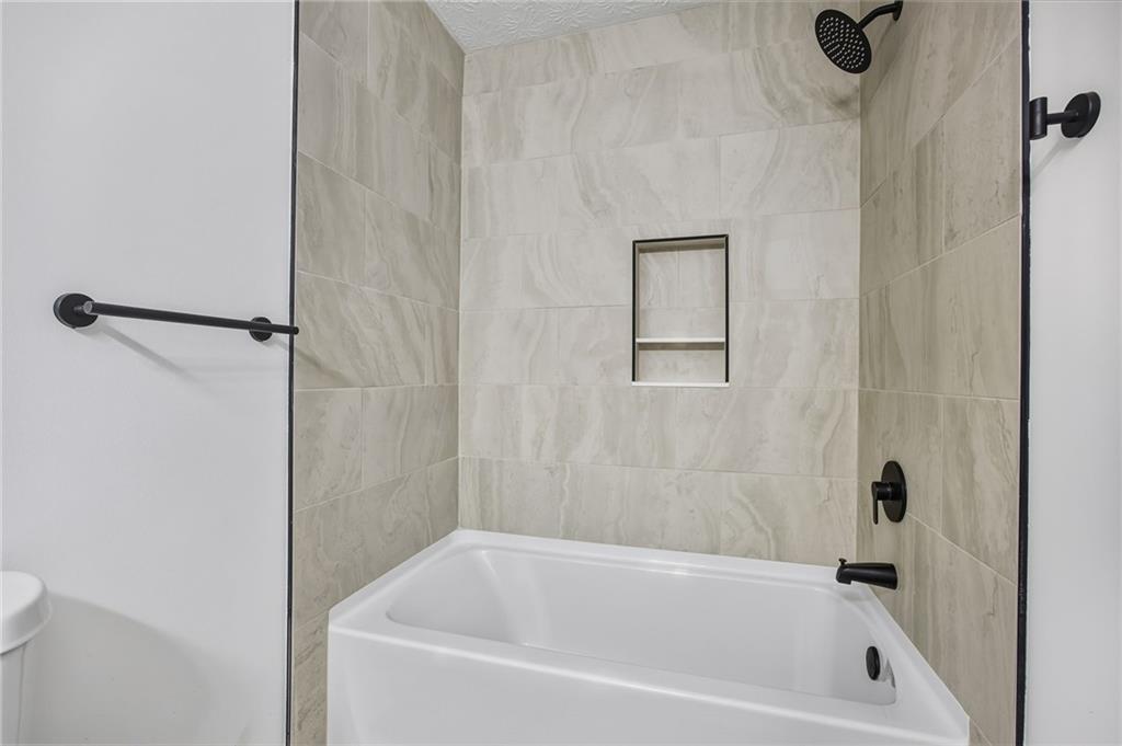 4457 Wesley Way Austell, GA 30106 - Photo 22 of 37 a bathroom with a tub