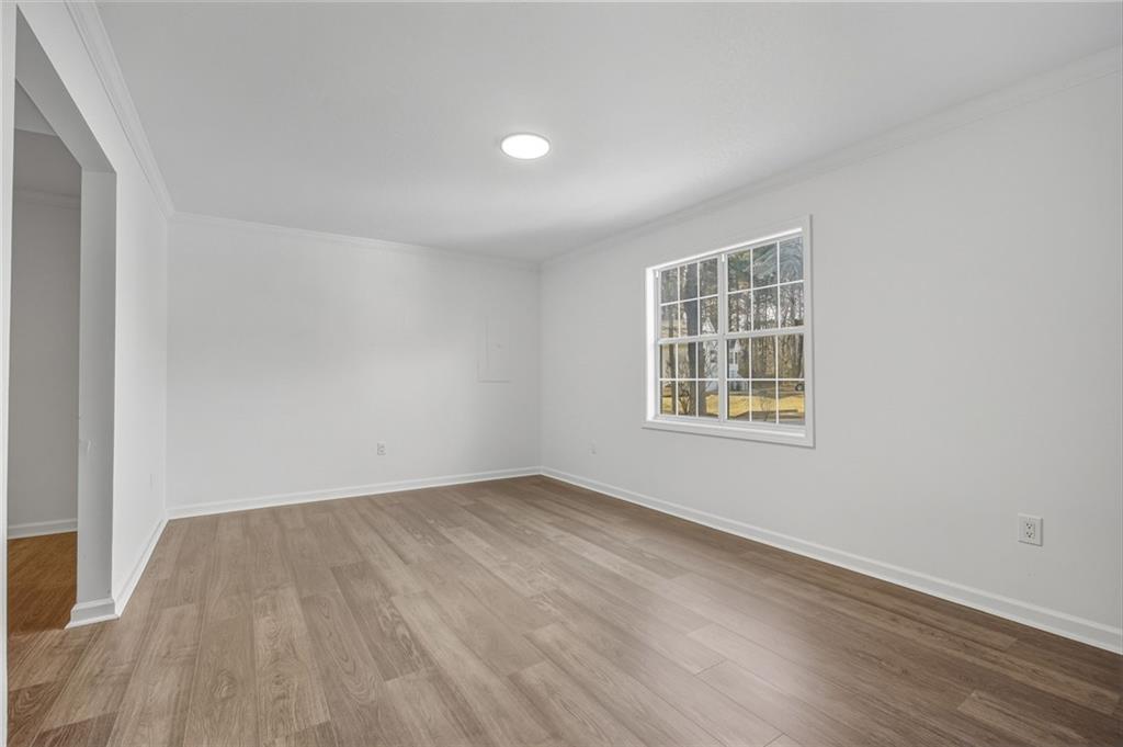 4457 Wesley Way Austell, GA 30106 - Photo 24 of 37 an empty room with wooden floor and windows