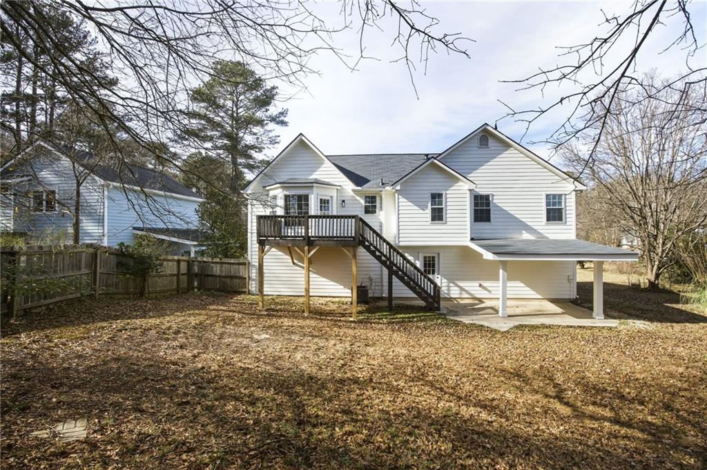 4457 Wesley Way Austell, GA 30106 - Photo 34 of 37 a view of a house with a yard covered in snow