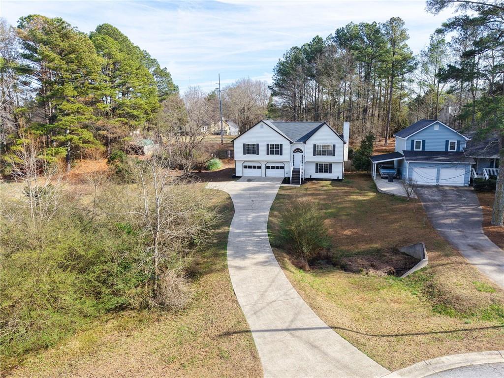 4457 Wesley Way Austell, GA 30106 - Photo 37 of 37 a front view of a house with a yard and garage