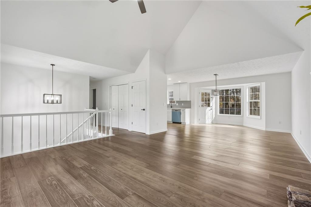 4457 Wesley Way Austell, GA 30106 - Photo 8 of 37 a view of an empty room with wooden floor and a window