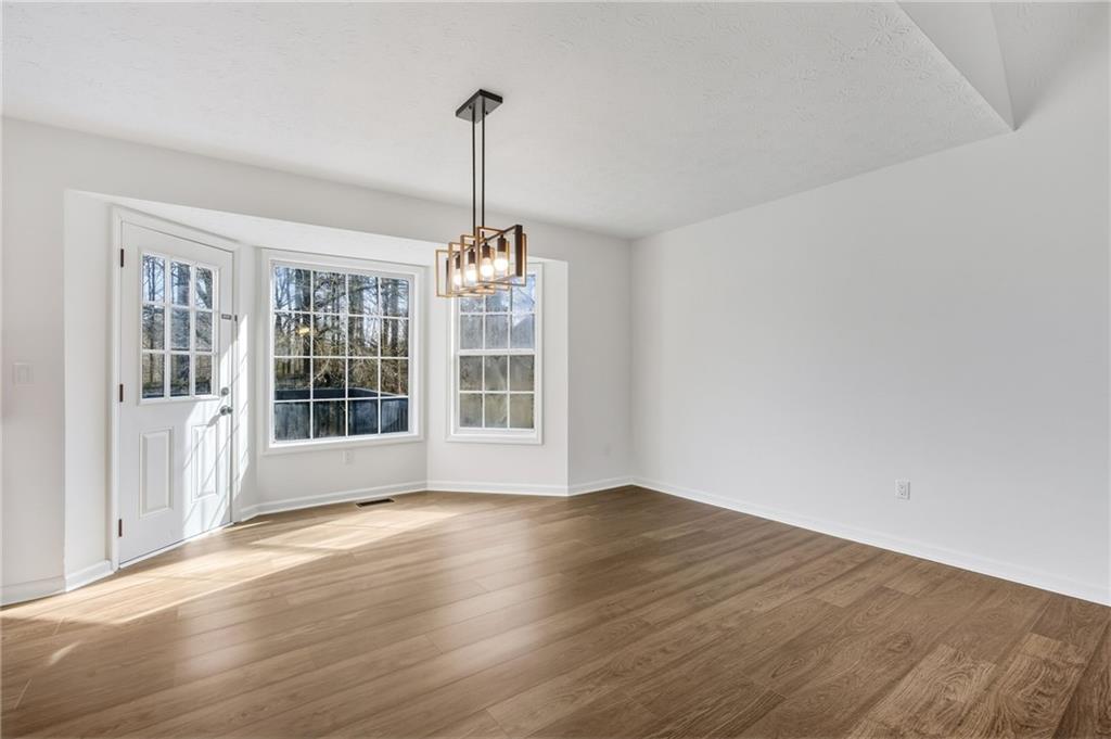 4457 Wesley Way Austell, GA 30106 - Photo 9 of 37 a view of empty room with wooden floor and window