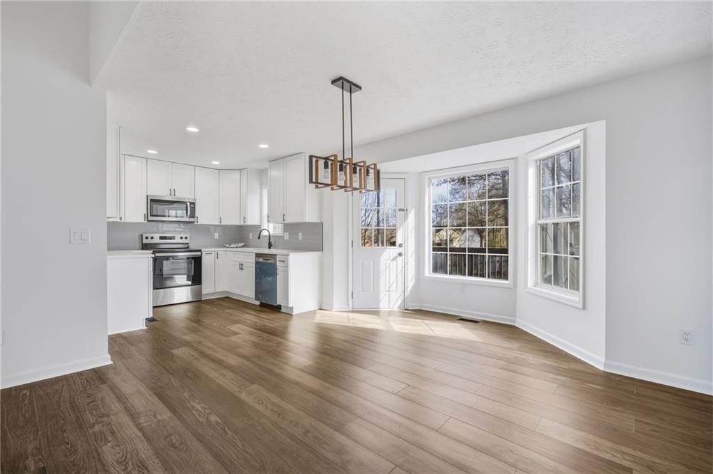4457 Wesley Way Austell, GA 30106 - Photo 10 of 37 a view of kitchen with granite countertop cabinets and refrigerator