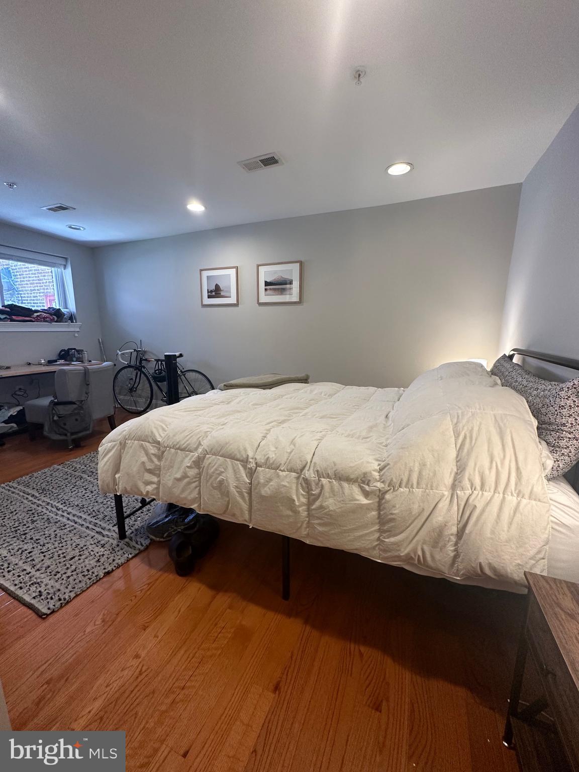 1014 Clinton Street, Unit 1R Philadelphia, PA 19107 - Photo 10 of 14 a bedroom with a bed and a large mirror