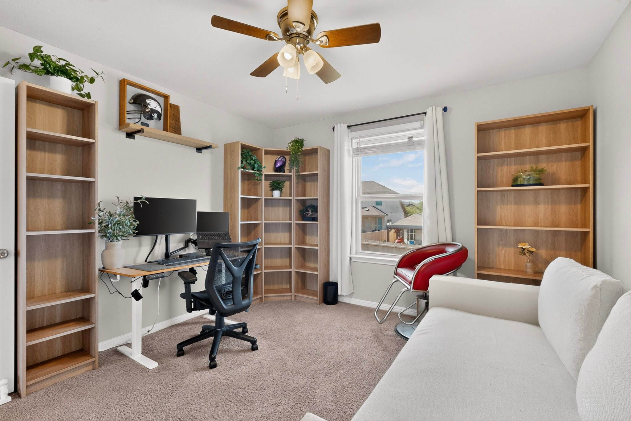 132 Wapiti Road Buda, TX 78610 - Photo 13 of 31 A versatile space for work or relaxation, featuring built-in shelving and a sun-filled window.