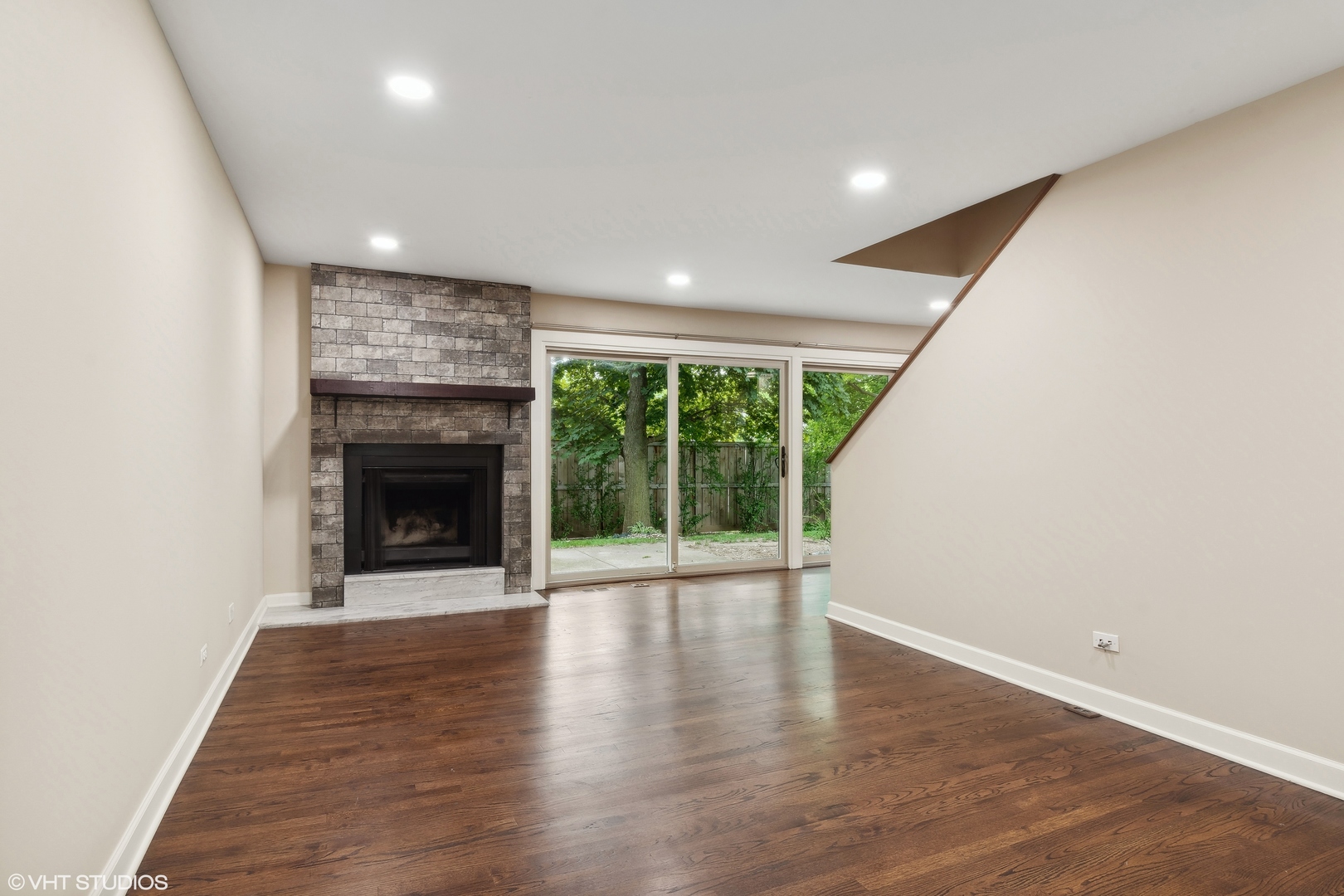 1649 Winnetka Road, Unit 1649 Glenview, IL 60025 - Photo 3 of 17 an empty room with wooden floor and fireplace