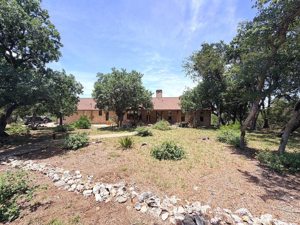 707 Rimrock Road Kerrville, TX 78028 - Photo 3 of 55 a view of a yard with plants and trees