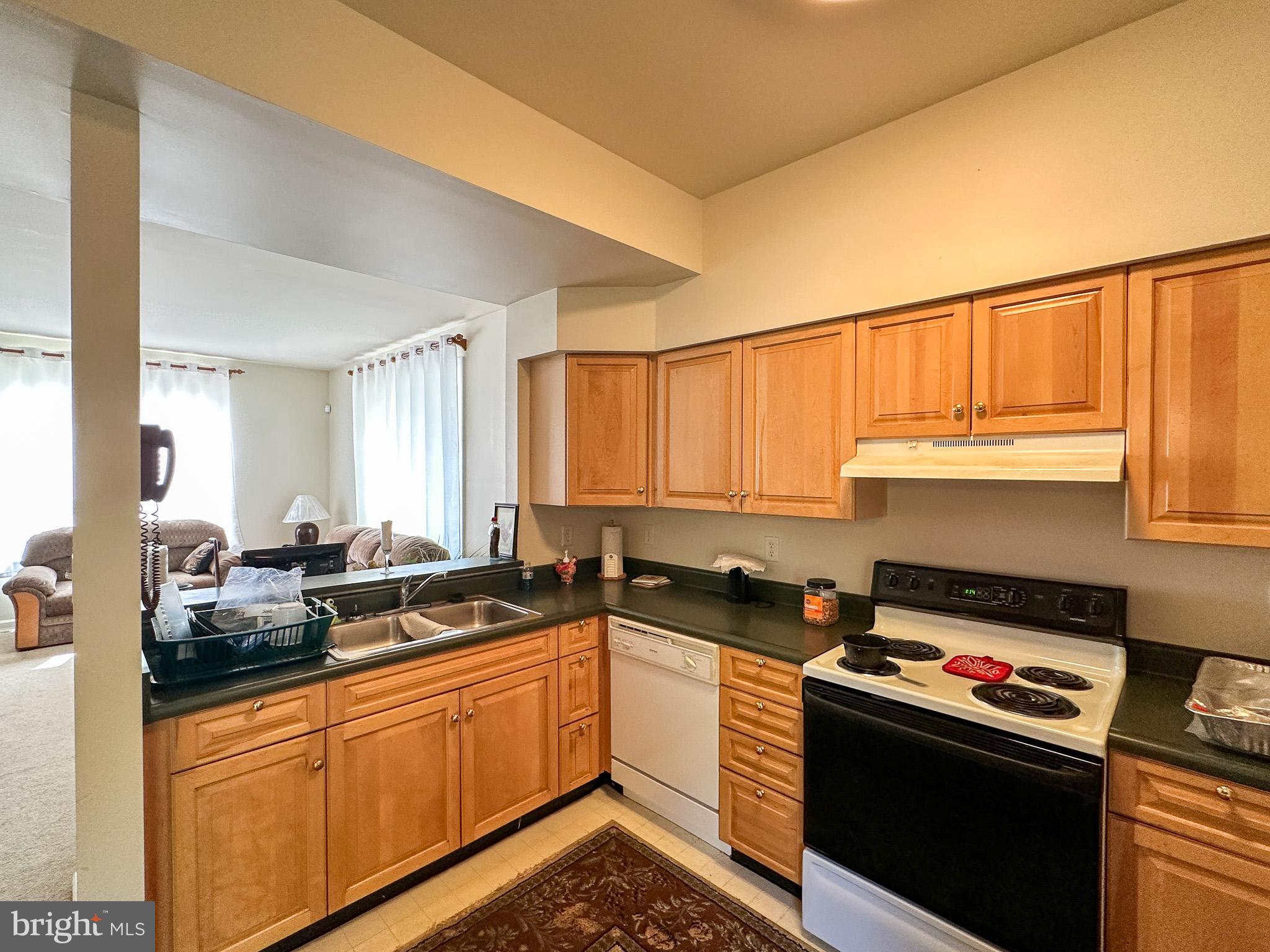901 Merchant Street Coatesville, PA 19320 - Photo 8 of 36 a kitchen with a sink stove and cabinets