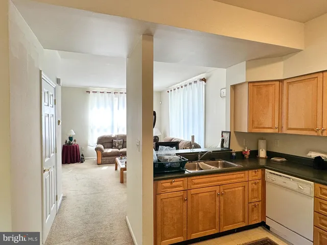 a kitchen with sink refrigerator and window