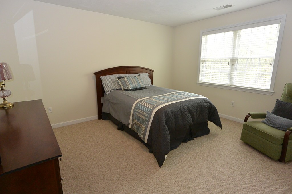 4 Harding Lane Sturbridge, MA 01518 - Photo 15 of 23 a bed sitting in a bedroom next to a window