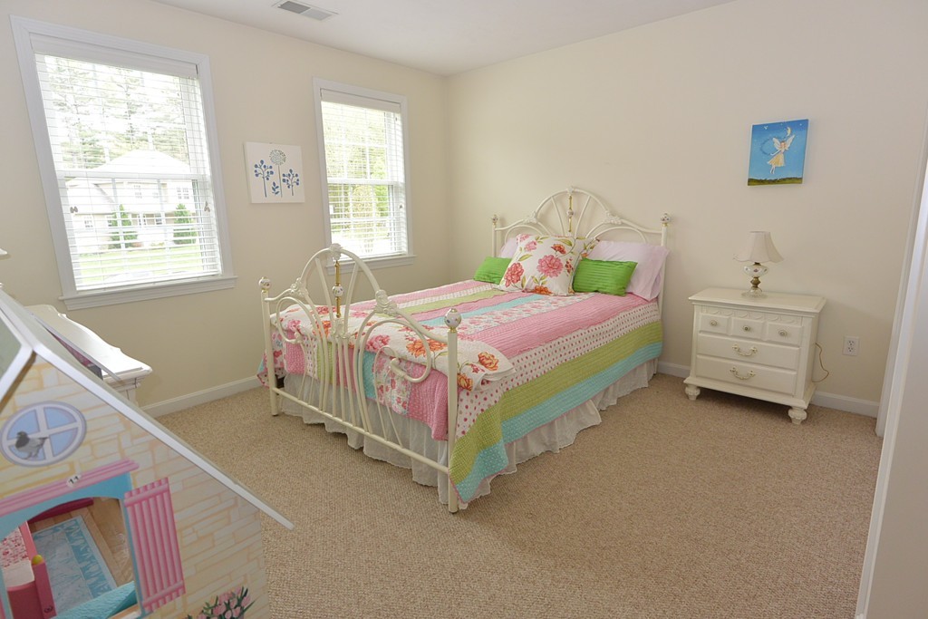 4 Harding Lane Sturbridge, MA 01518 - Photo 16 of 23 a bed sitting in a bedroom next to a window