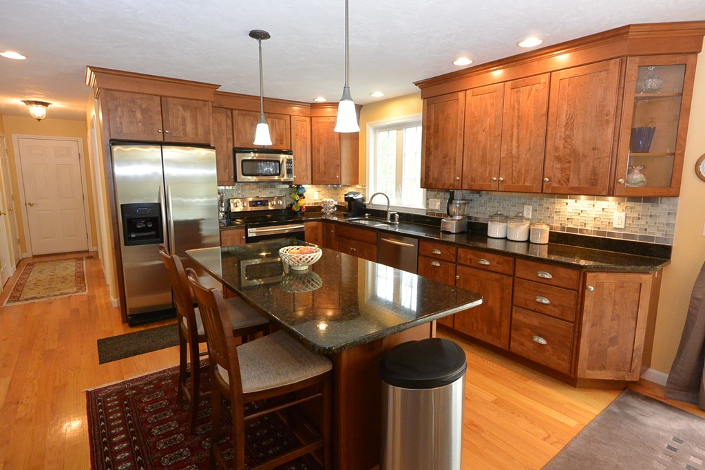 4 Harding Lane Sturbridge, MA 01518 - Photo 2 of 23 a kitchen with stainless steel appliances granite countertop a sink a stove a refrigerator cabinets and a dining table