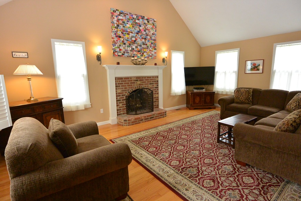 4 Harding Lane Sturbridge, MA 01518 - Photo 4 of 23 a living room with furniture a flat screen tv and a fireplace