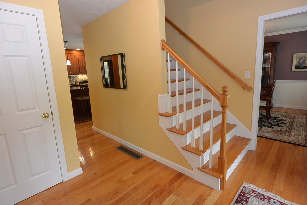 4 Harding Lane Sturbridge, MA 01518 - Photo 10 of 23 a view of an entryway with wooden floor and staircase