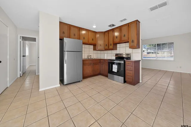 a kitchen with granite countertop cabinets and steel stainless steel appliances