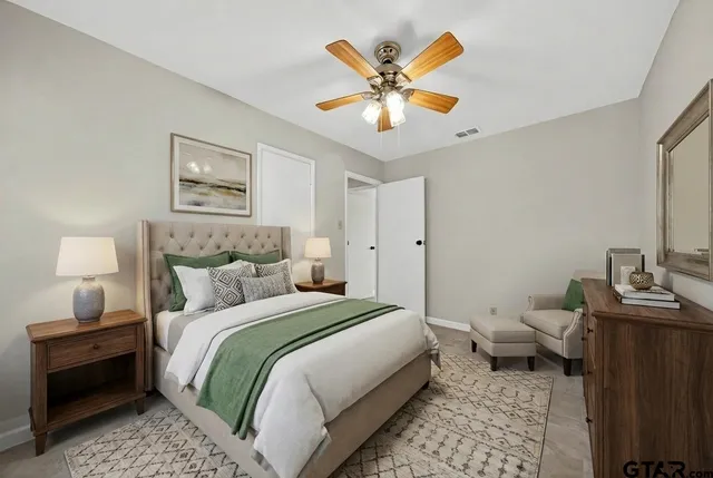 a bathroom with a granite countertop sink a toilet and a mirror