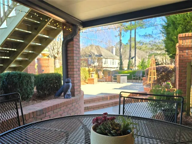 a living room with a floor to ceiling window and wooden floor