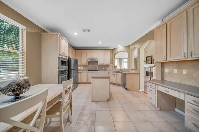 a kitchen with a sink cabinets and stainless steel appliances