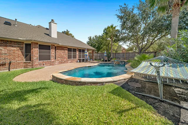 a view of a house with backyard sitting area and garden