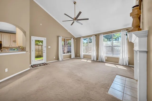 a view of a livingroom with furniture ceiling fan and window