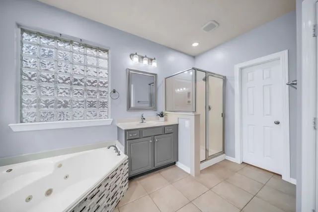a bathroom with a bathtub sink and mirror