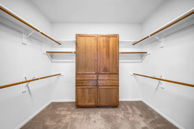 a view of a hallway with wooden floors and stairs