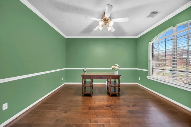 a room with pool table and windows