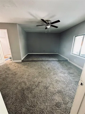 an empty room with a empty space and windows