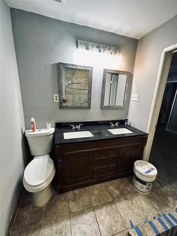 a bathroom with a toilet and a sink
