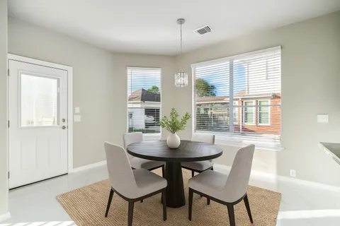 a dining room with furniture and window