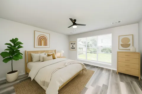 a spacious bedroom with a large bed and a window