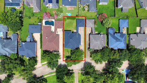 an aerial view of house with a yard and swimming pool