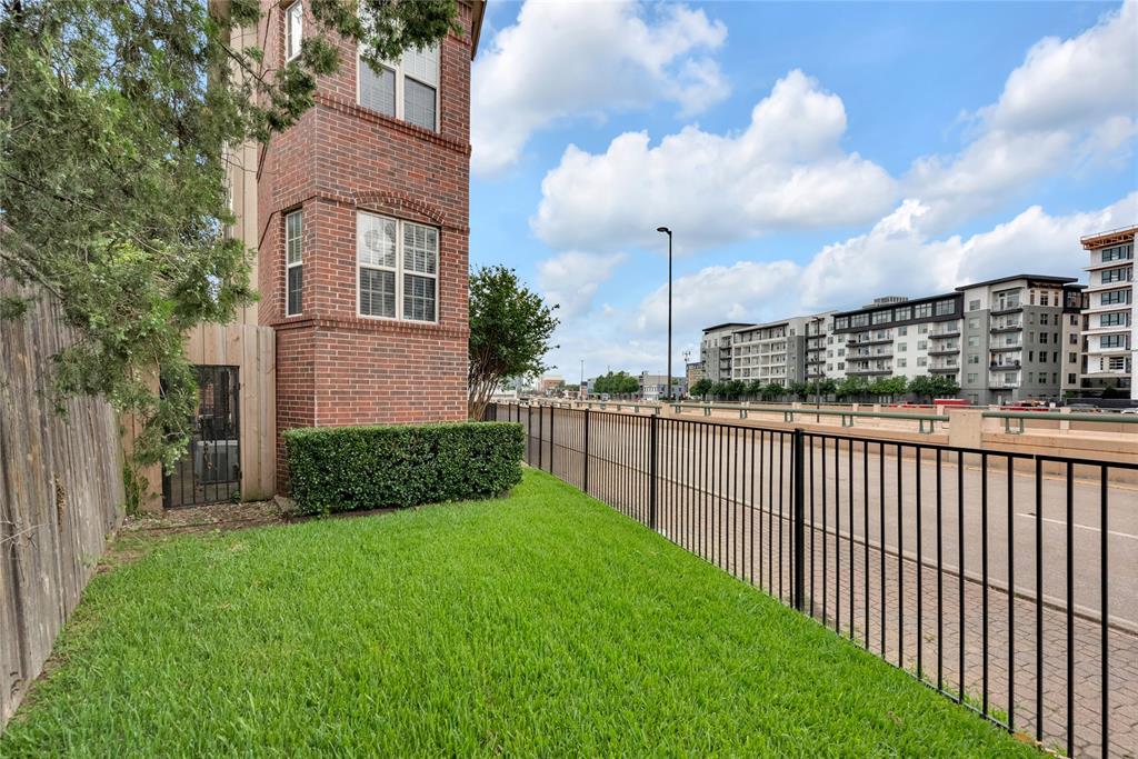 5102 Ridgedale Avenue Dallas, TX 75206 - Photo 22 of 27 Brick exterior featuring multiple windows with arched detailing