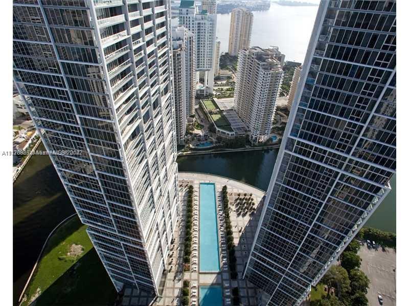 a view of a balcony with tall buildings