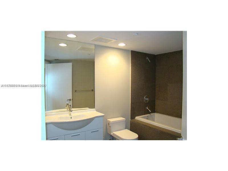 475 Brickell Avenue, Unit 808 Miami, FL 33131 - Photo 5 of 12 a bathroom with a sink and a mirror