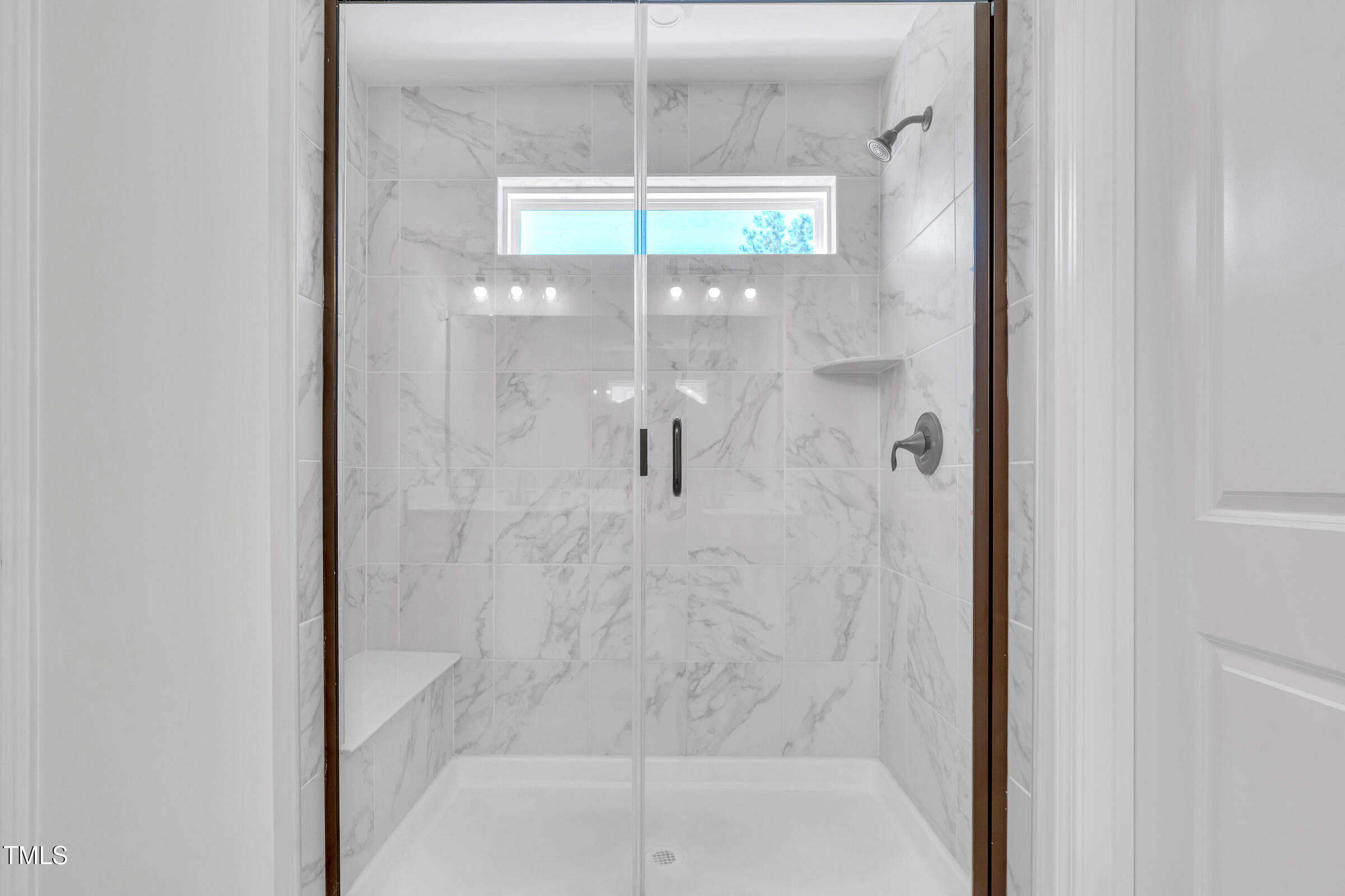 61 Cascade Place Clayton, NC 27527 - Photo 17 of 33 a bathroom with a glass shower door