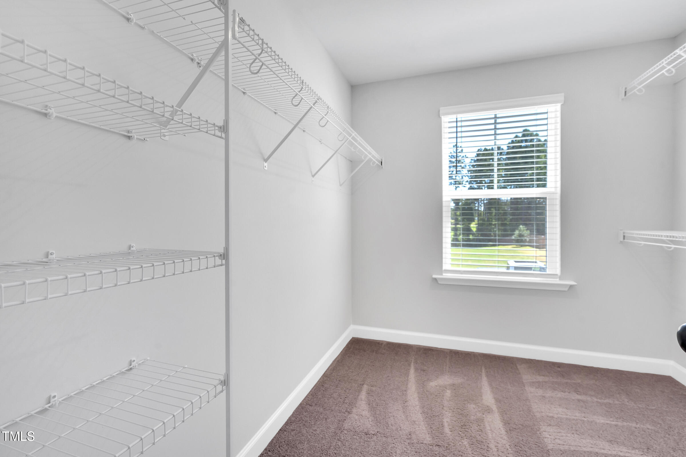 61 Cascade Place Clayton, NC 27527 - Photo 20 of 33 a view of a room with racks on the wall and window