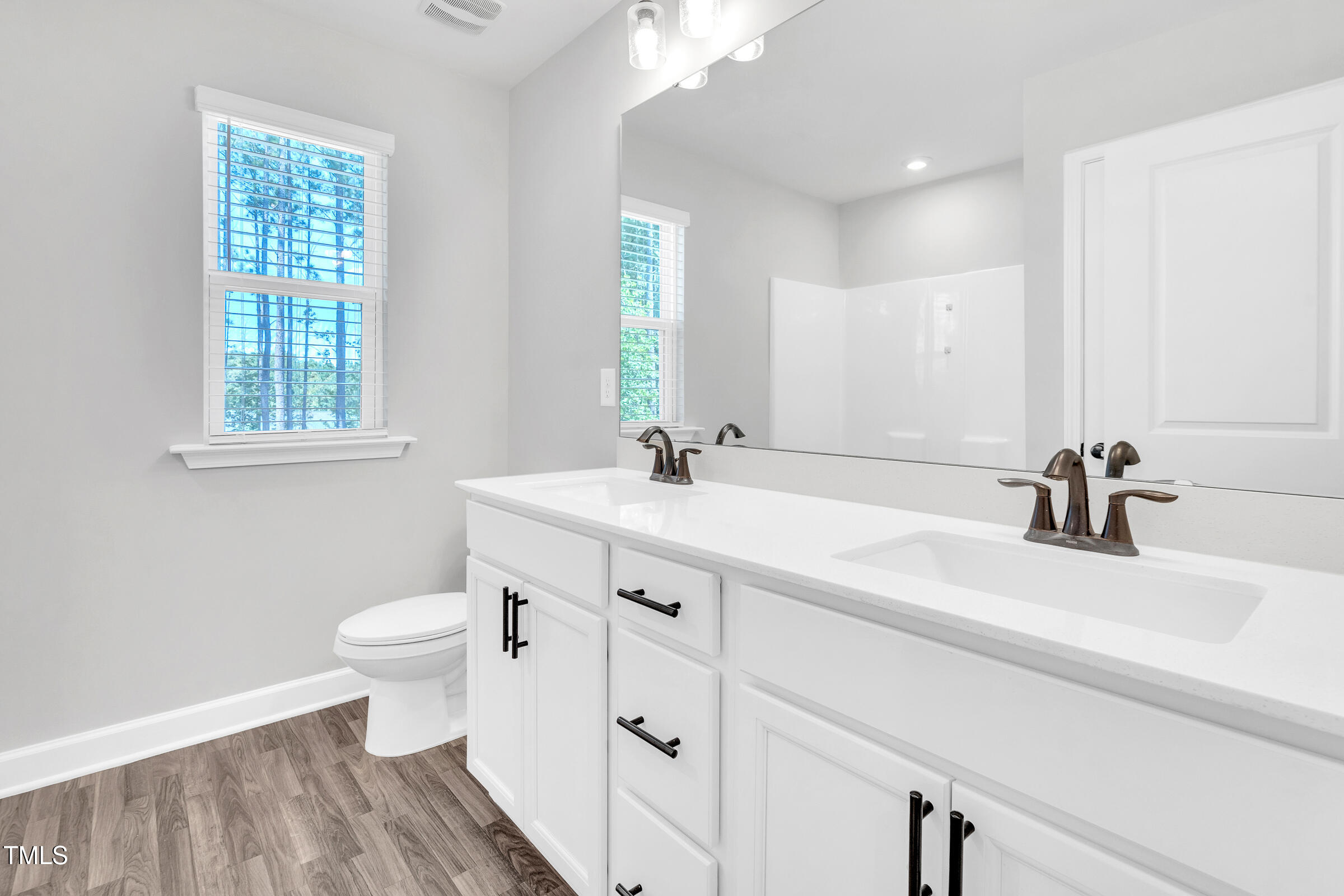61 Cascade Place Clayton, NC 27527 - Photo 21 of 33 a bathroom with a sink a toilet and a mirror