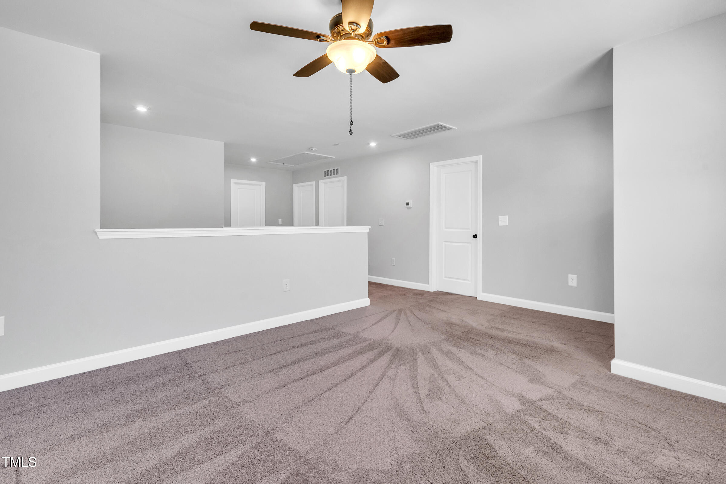 61 Cascade Place Clayton, NC 27527 - Photo 23 of 33 an empty room with chandelier fan and wooden floor