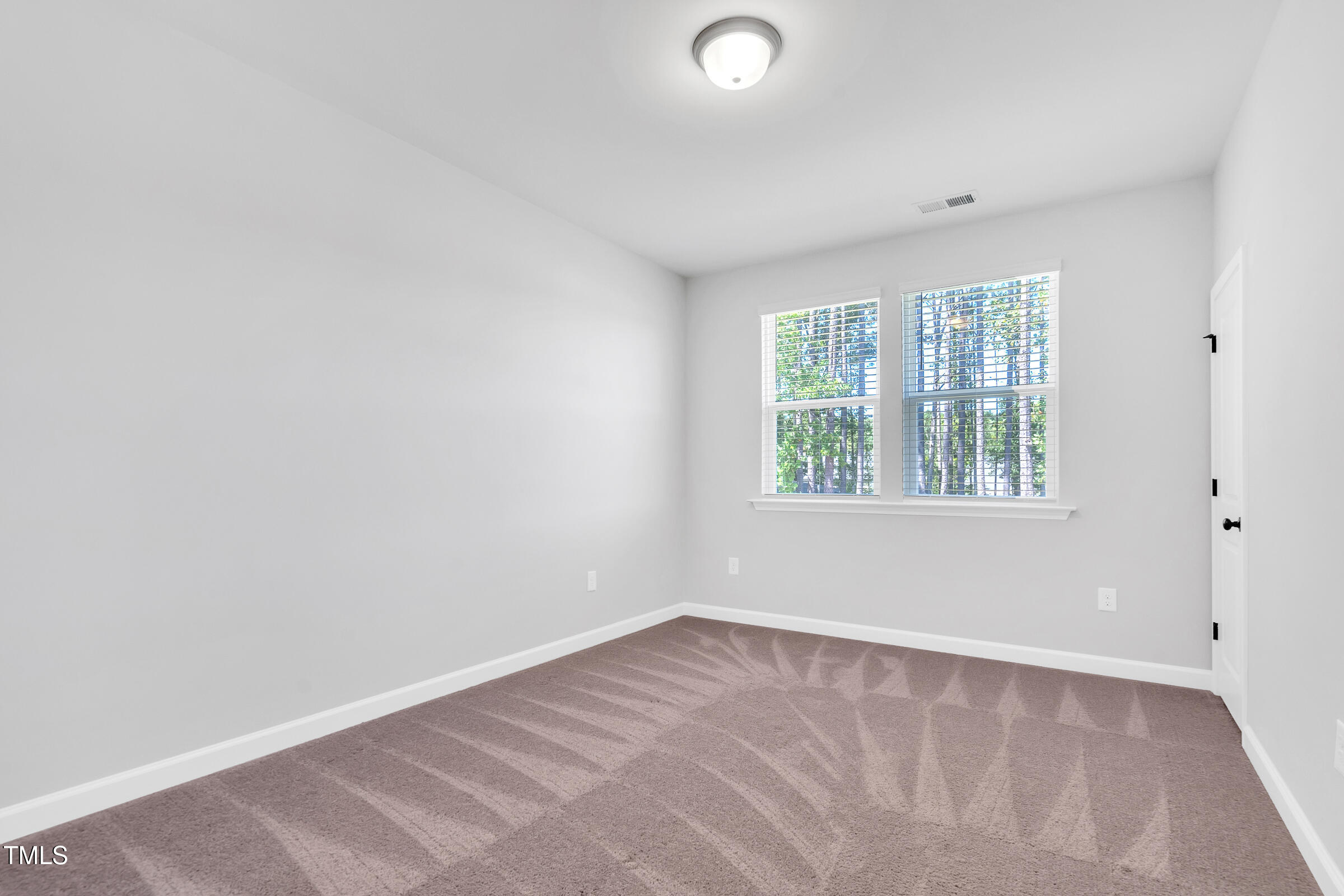 61 Cascade Place Clayton, NC 27527 - Photo 24 of 33 an empty room with a window