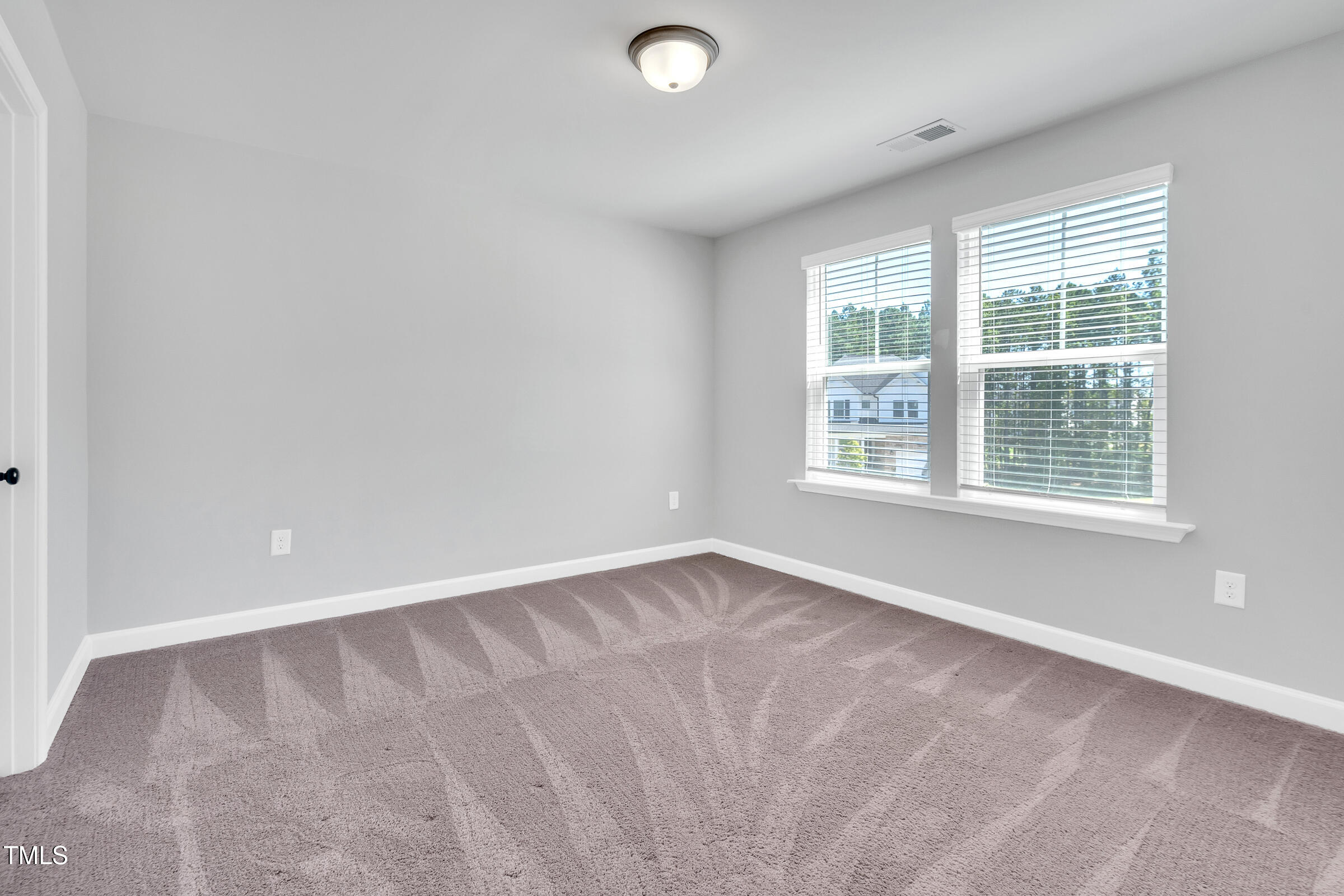 61 Cascade Place Clayton, NC 27527 - Photo 25 of 33 a view of an empty room with a window