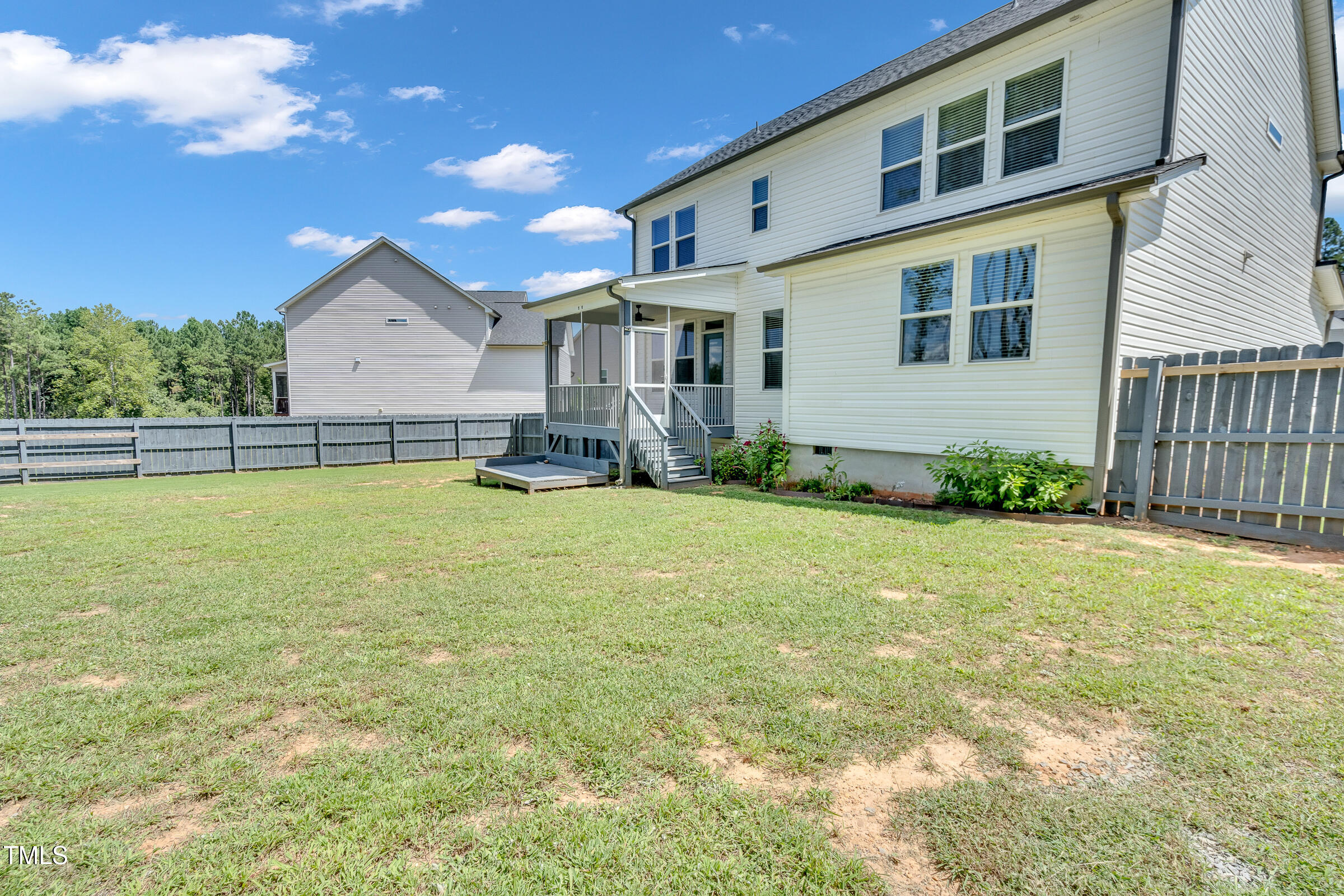 61 Cascade Place Clayton, NC 27527 - Photo 32 of 33 a backyard of a house with table and chairs