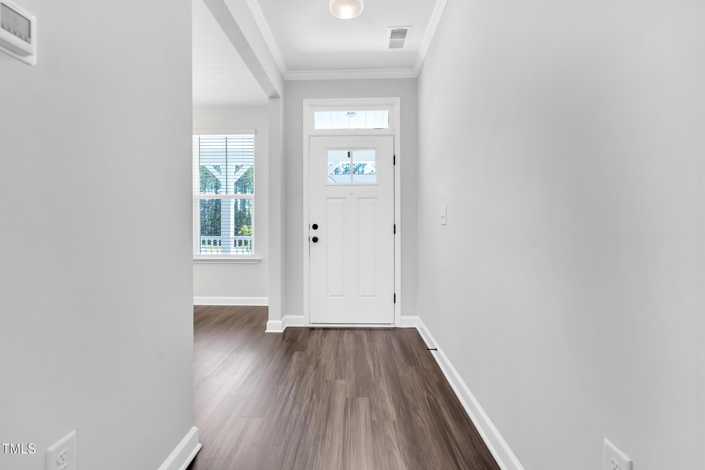 61 Cascade Place Clayton, NC 27527 - Photo 4 of 33 an empty room with wooden floor and windows