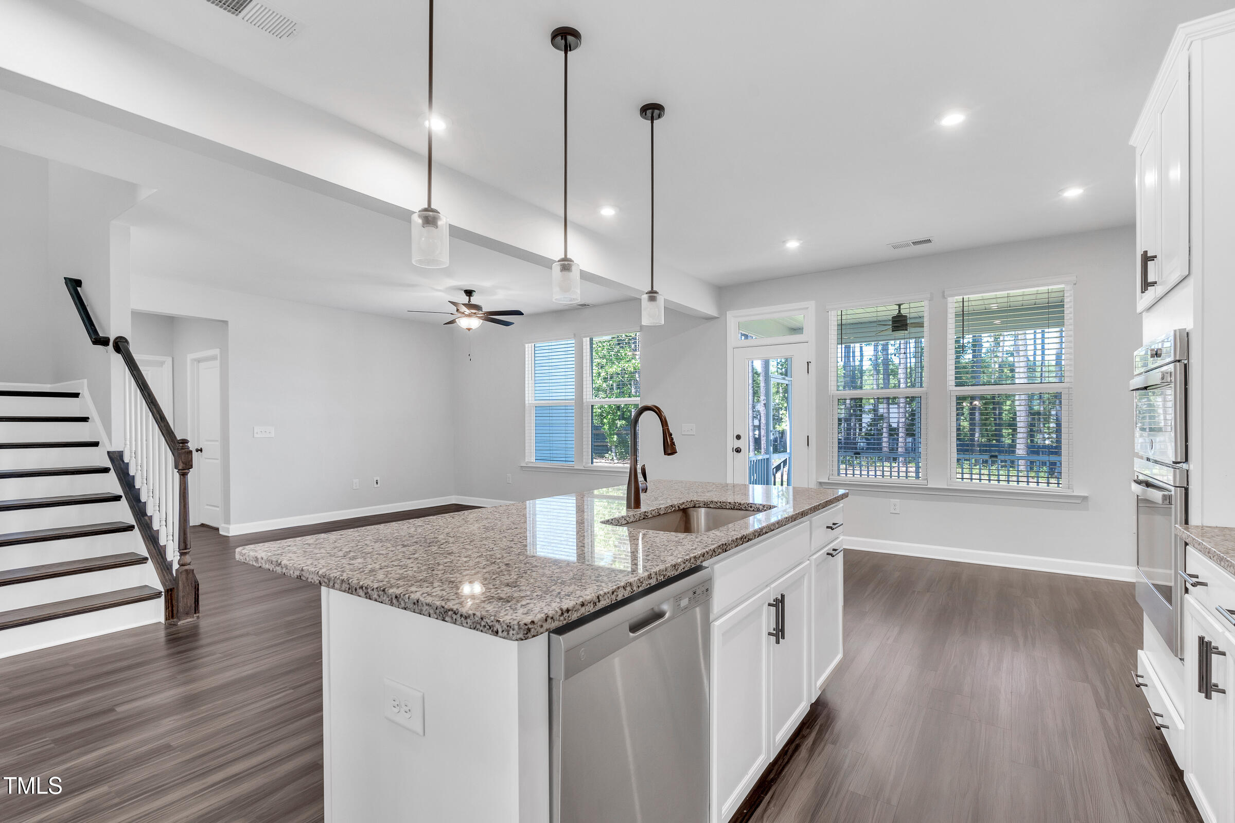 61 Cascade Place Clayton, NC 27527 - Photo 9 of 33 a white kitchen with a sink and wooden floor