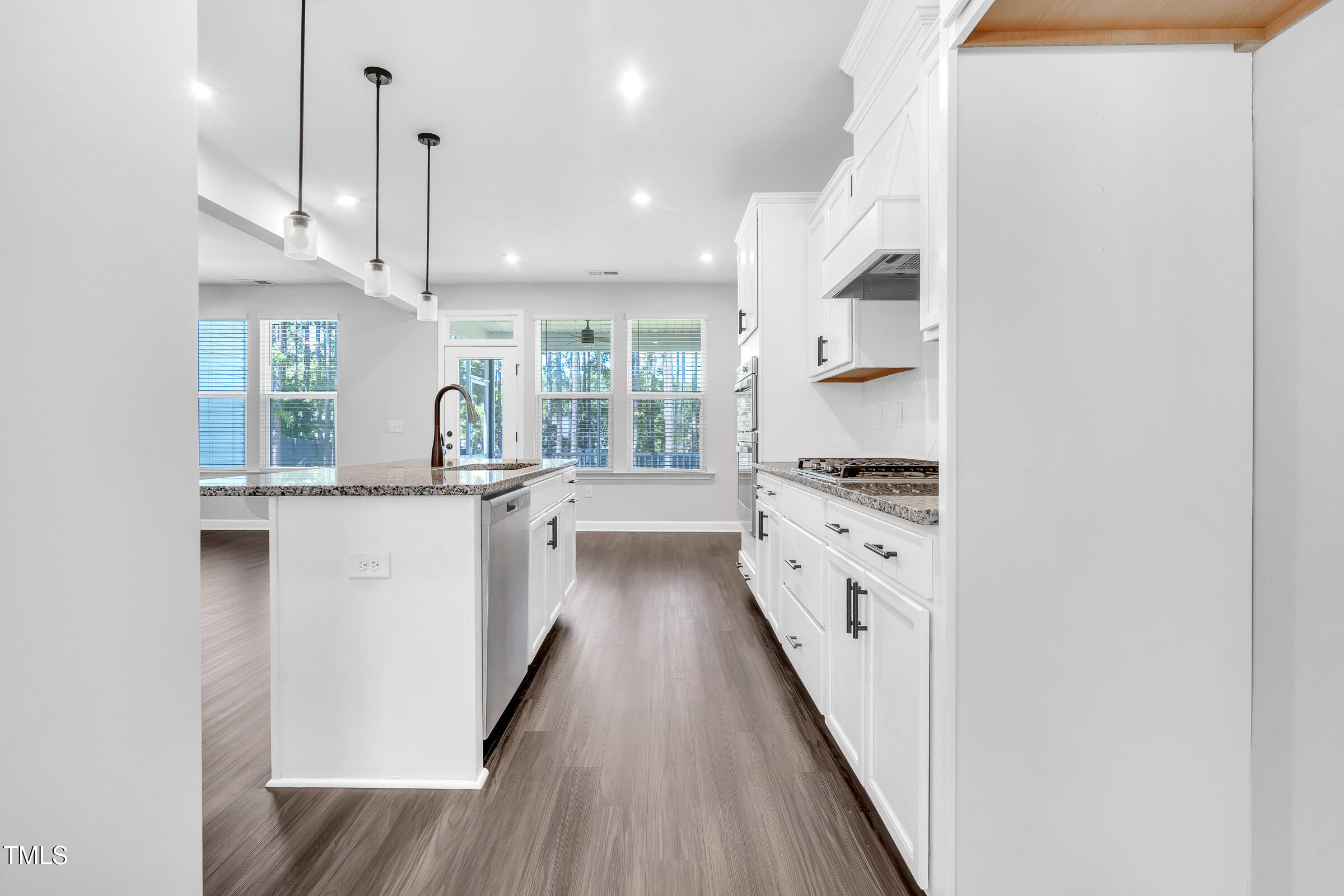 61 Cascade Place Clayton, NC 27527 - Photo 10 of 33 a large white kitchen with a large window a sink and stainless steel appliances