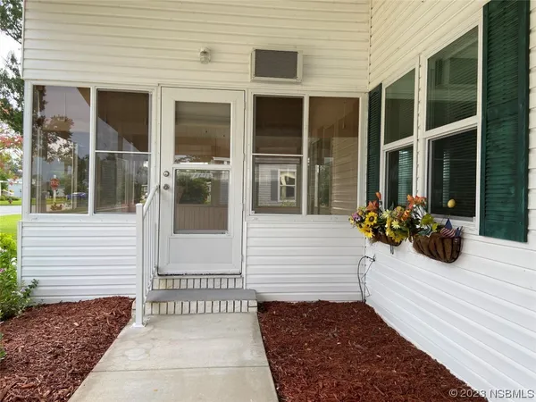 a kitchen with stainless steel appliances a microwave a stove and white cabinets